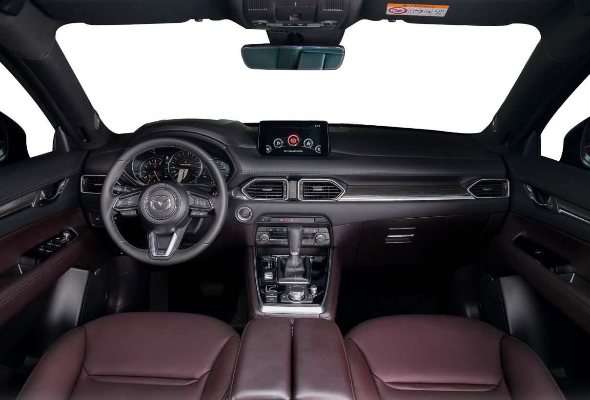Bên trong khoang nội thất, Mazda CX-8 2022 được bổ sung cửa sổ trời, sấy gương, màn hình đa thông tin 7 inch, màn hình trung tâm 8 inch, sưởi tay lái và sạc không dây. Hàng ghế trước trang bị ghế chỉnh điện, tích hợp sưởi ghế, ghế lái có tính năng nhớ vị trí như phiên bản tiền nhiệm nhưng được tích hợp tính năng mới bơm lưng ghế